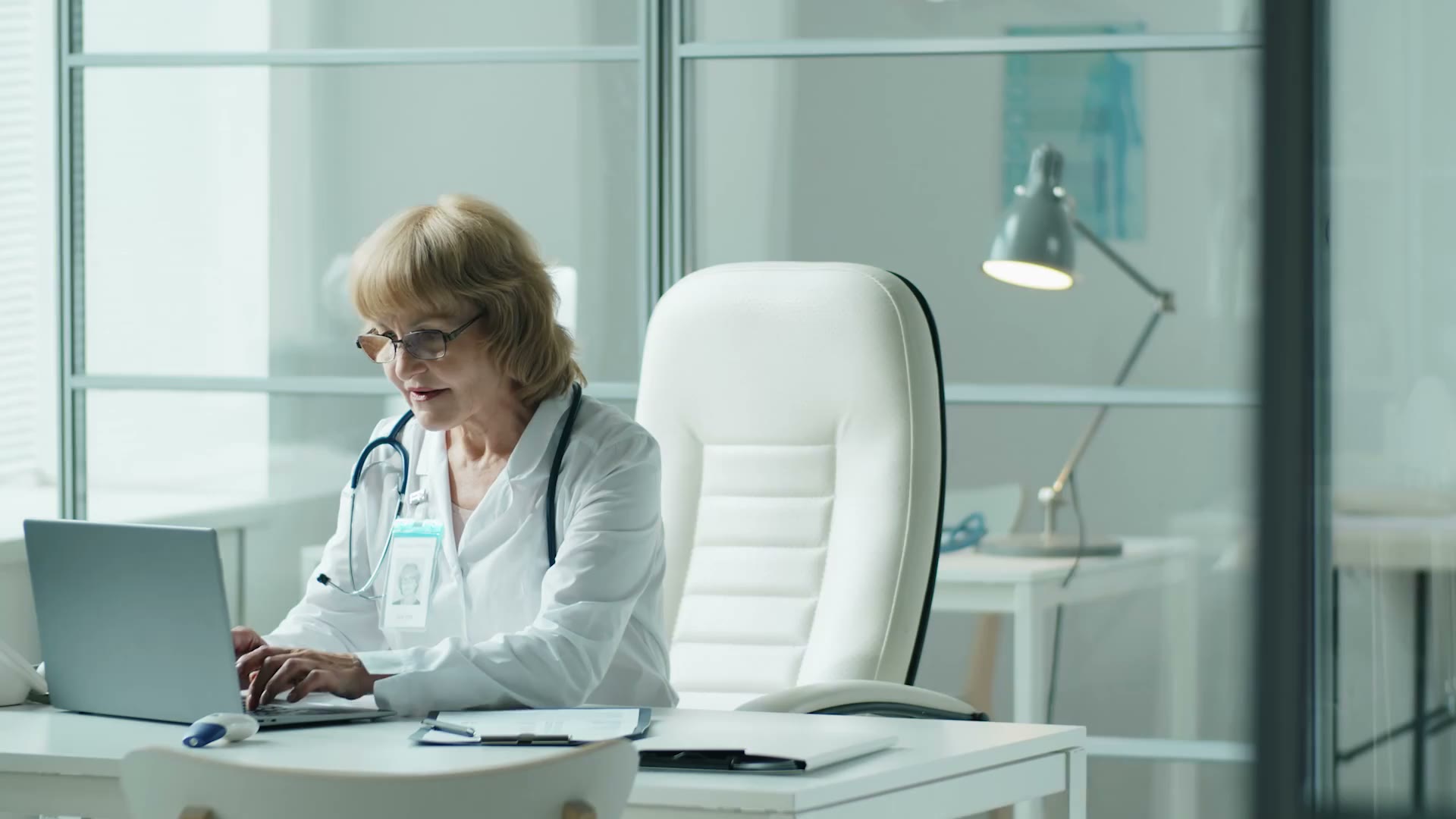 A physician working at a clinical workstation